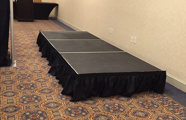 Black portable stage indoor with curtains