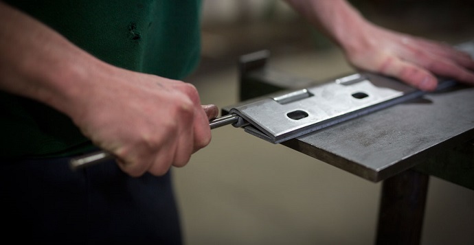 man testing a piano door hinge 