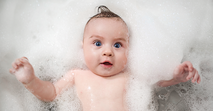 baby in bath amongst bubbles