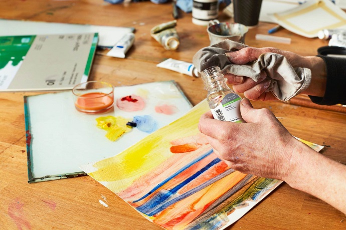 artist working with paint medium